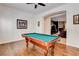 Bright game room features a billiard table, ceiling fan, and hardwood flooring at 3518 W Agate Ave, Las Vegas, NV 89139