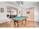 Open game room features a billiard table, hardwood floors and views into the Gathering room at 3518 W Agate Ave, Las Vegas, NV 89139