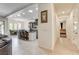 Hallway view into kitchen with ample lighting, island and dining area beyond at 3518 W Agate Ave, Las Vegas, NV 89139
