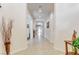 Hallway featuring neutral tile flooring, arched doorways, and bright, neutral paint at 3518 W Agate Ave, Las Vegas, NV 89139