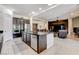 Kitchen features island with seating, stainless steel appliances, and is open to the living room at 3518 W Agate Ave, Las Vegas, NV 89139