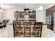 Kitchen featuring a center island with bar seating, dark cabinetry, and stainless steel appliances at 3518 W Agate Ave, Las Vegas, NV 89139