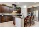 Kitchen featuring a center island with bar seating, dark cabinetry, and stainless steel appliances at 3518 W Agate Ave, Las Vegas, NV 89139