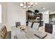 Open kitchen with dark wood cabinets, granite countertops, and a dining area featuring a wooden table at 3518 W Agate Ave, Las Vegas, NV 89139