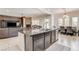 Open-concept kitchen with an island and living room area provides an inclusive and social living space at 3518 W Agate Ave, Las Vegas, NV 89139