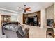 Open-concept living area with tiled floors, a fireplace, and comfortable seating at 3518 W Agate Ave, Las Vegas, NV 89139