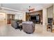 Spacious living room with leather seating, a decorative fireplace, and tiled flooring at 3518 W Agate Ave, Las Vegas, NV 89139