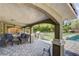Outdoor patio with seating area, built in barbecue, lush green grass, trees, and a swimming pool at 3518 W Agate Ave, Las Vegas, NV 89139