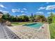 Inviting backyard pool with manicured landscaping and a brick patio for outdoor lounging at 3518 W Agate Ave, Las Vegas, NV 89139