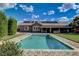 Backyard pool surrounded by green lawn and features a covered patio at 3518 W Agate Ave, Las Vegas, NV 89139
