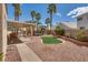 Expansive backyard with covered patio, lush landscaping, and a sparkling swimming pool at 3800 Crema Ct, Las Vegas, NV 89129