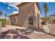 Side view of the home's backyard, featuring desert landscaping and covered patio at 3800 Crema Ct, Las Vegas, NV 89129