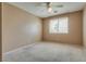 Bedroom features a ceiling fan, neutral walls, and a window to allow natural light at 3800 Crema Ct, Las Vegas, NV 89129