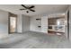 Spacious bedroom featuring soft carpet, a ceiling fan, and neutral walls with access to the main bath at 3800 Crema Ct, Las Vegas, NV 89129
