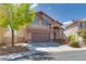 Charming two-story home features a two-car garage and well-manicured landscaping at 3800 Crema Ct, Las Vegas, NV 89129