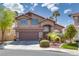 Charming two-story home with a two-car garage and mature palm tree in the front yard at 3800 Crema Ct, Las Vegas, NV 89129
