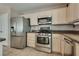 The kitchen includes stainless steel appliances and ample storage at 3800 Crema Ct, Las Vegas, NV 89129