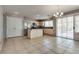 Bright eat-in kitchen featuring stainless steel appliances, island, and sliding glass doors at 3800 Crema Ct, Las Vegas, NV 89129