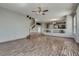 Open-concept living room boasts wood floors, fan, and seamless flow into the kitchen at 3800 Crema Ct, Las Vegas, NV 89129