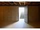 Unfinished basement featuring concrete walls, exposed ceiling, and doorway leading to the stairs at 3900 W Landberg Ave, Las Vegas, NV 89141
