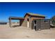 Rustic outbuilding with ample storage space, a carport, and desert landscaping at 3900 W Landberg Ave, Las Vegas, NV 89141