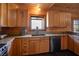 Bright kitchen features wooden cabinets and a large window over the sink at 3900 W Landberg Ave, Las Vegas, NV 89141