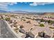 Aerial view of the neighborhood displaying many single-Gathering homes with tile roofs and well-maintained landscapes at 4416 Peaceful Morning Ln, Las Vegas, NV 89129
