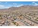 Scenic aerial view of a well-planned community with winding roads and desert mountain views in the distance at 4416 Peaceful Morning Ln, Las Vegas, NV 89129