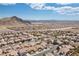 Expansive aerial view of a neighborhood featuring desert landscaping and mountain views in the distance, offering a serene environment at 4416 Peaceful Morning Ln, Las Vegas, NV 89129