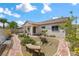Well-manicured backyard oasis featuring desert landscaping, a red brick walkway, and a cozy sitting area with bench at 4416 Peaceful Morning Ln, Las Vegas, NV 89129