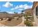 Landscaped backyard with pathway, benches, and desert plants at 4416 Peaceful Morning Ln, Las Vegas, NV 89129
