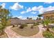 Landscaped backyard with pathway, benches, and desert plants at 4416 Peaceful Morning Ln, Las Vegas, NV 89129