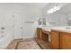 Bathroom with double vanity, cabinetry, and a tile-trimmed tub at 4416 Peaceful Morning Ln, Las Vegas, NV 89129