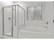 Clean and modern bathroom with a glass-enclosed shower and soaking tub at 4416 Peaceful Morning Ln, Las Vegas, NV 89129