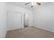 Well-lit bedroom features carpet, a ceiling fan, and closet at 4416 Peaceful Morning Ln, Las Vegas, NV 89129