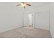 Bright bedroom featuring a ceiling fan, carpet, and closet at 4416 Peaceful Morning Ln, Las Vegas, NV 89129