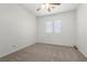Carpeted bedroom with a window and ceiling fan providing natural light at 4416 Peaceful Morning Ln, Las Vegas, NV 89129