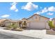Charming single-story home showcasing desert landscaping and a two-car garage at 4416 Peaceful Morning Ln, Las Vegas, NV 89129