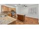 Well-lit kitchen features granite counters, stainless steel appliances, kitchen island, and tile floors at 4416 Peaceful Morning Ln, Las Vegas, NV 89129