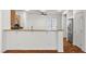 Kitchen with breakfast bar area offering seamless transition into an open living space with natural lighting at 4416 Peaceful Morning Ln, Las Vegas, NV 89129