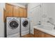 Laundry room with washer, dryer, cabinets, and utility sink at 4416 Peaceful Morning Ln, Las Vegas, NV 89129