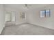 Bright bedroom features a ceiling fan, large windows, carpeted floors, and a mirrored closet at 5170 S Jones Blvd # 205, Las Vegas, NV 89118