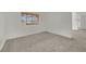 Spacious bedroom features neutral carpeting, white walls, and a window with vertical blinds at 5170 S Jones Blvd # 205, Las Vegas, NV 89118