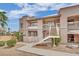 Condominium exterior featuring multiple levels, desert landscaping, and common stairwells accessing the units at 5170 S Jones Blvd # 205, Las Vegas, NV 89118
