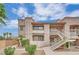 Condominium exterior with multiple levels and desert landscaping and common stairwells accessing units at 5170 S Jones Blvd # 205, Las Vegas, NV 89118