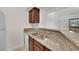 Kitchen sink with granite countertops, wooden cabinets, stainless steel sink and a window view to the community at 5170 S Jones Blvd # 205, Las Vegas, NV 89118