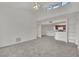 Open concept living room with neutral carpet, high ceilings, and view to kitchen space, complete with fan at 5170 S Jones Blvd # 205, Las Vegas, NV 89118