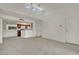 Open concept living room boasts high ceilings, neutral carpet, and views into the kitchen, complete with fan at 5170 S Jones Blvd # 205, Las Vegas, NV 89118