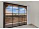 View from the patio, with black frame sliding glass doors and curtains at 5170 S Jones Blvd # 205, Las Vegas, NV 89118