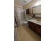 Neat bathroom with a combination of shower and tub, and a decorative mirror at 5268 Gains Mill St, Las Vegas, NV 89122